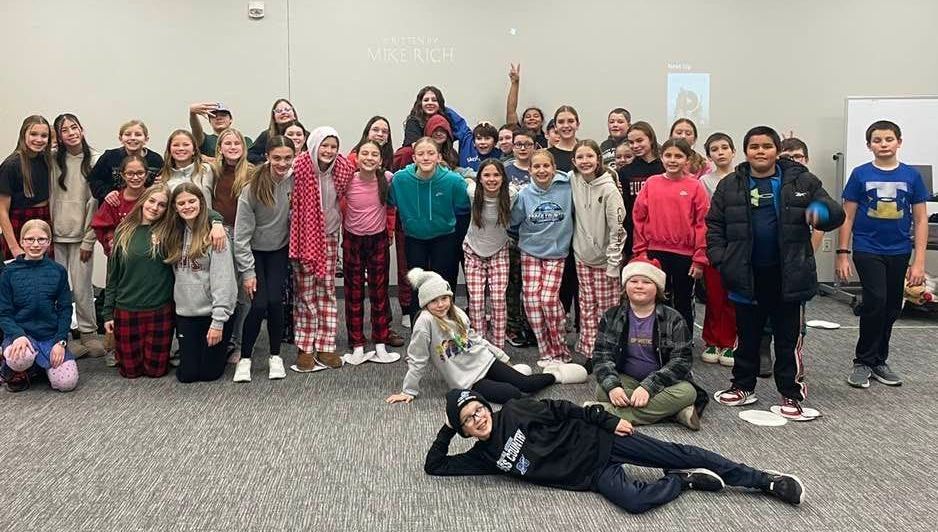 A group of children are posing for a picture in a room.