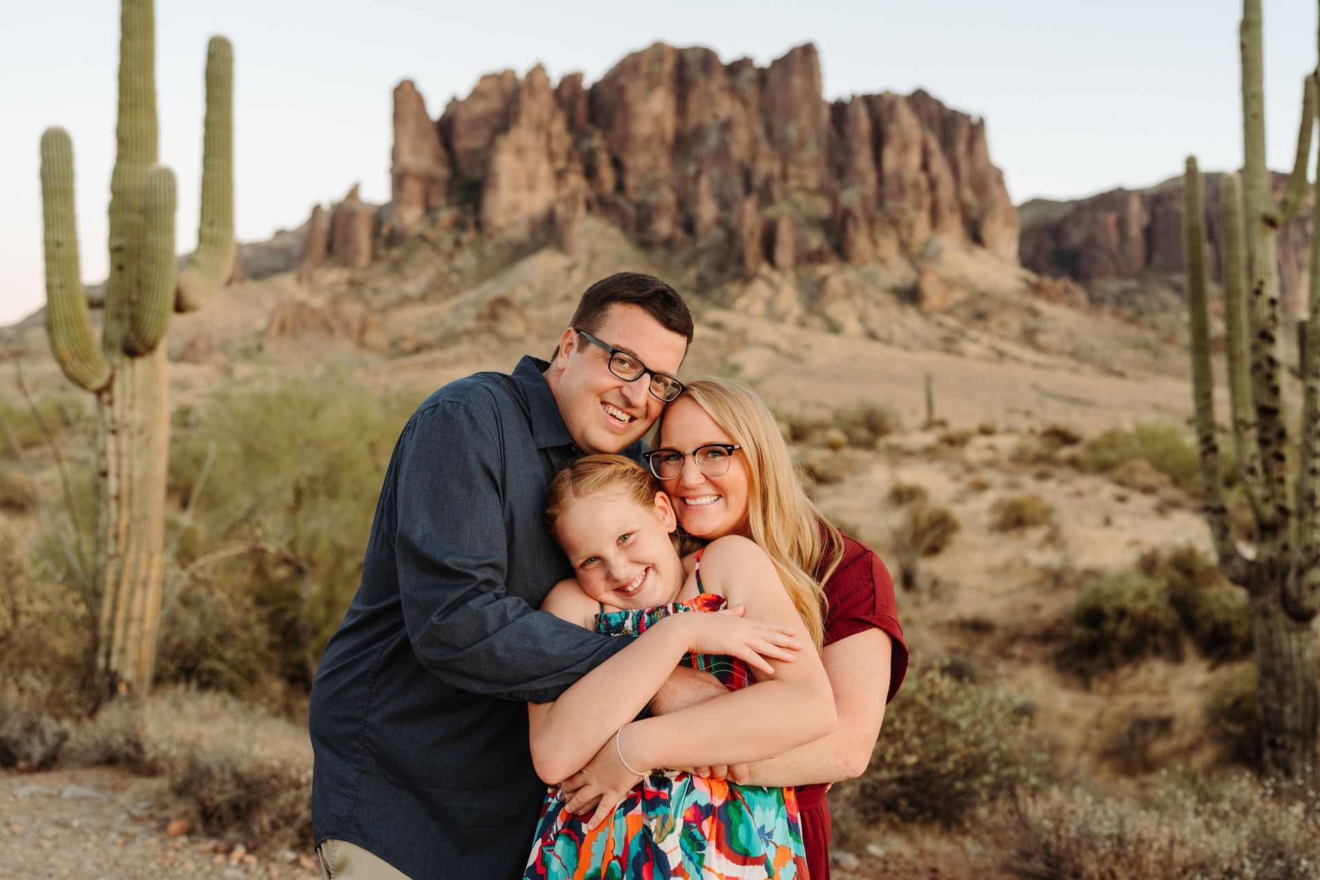 A family is posing for a picture in the desert.