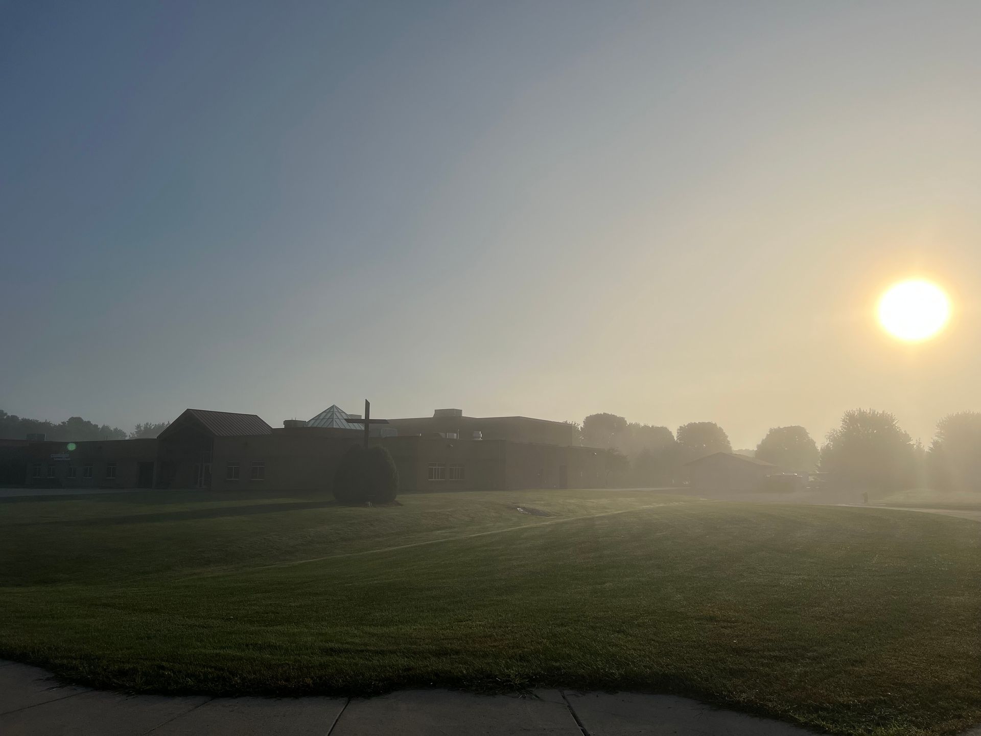 A wooden cross with a white cloth draped over it