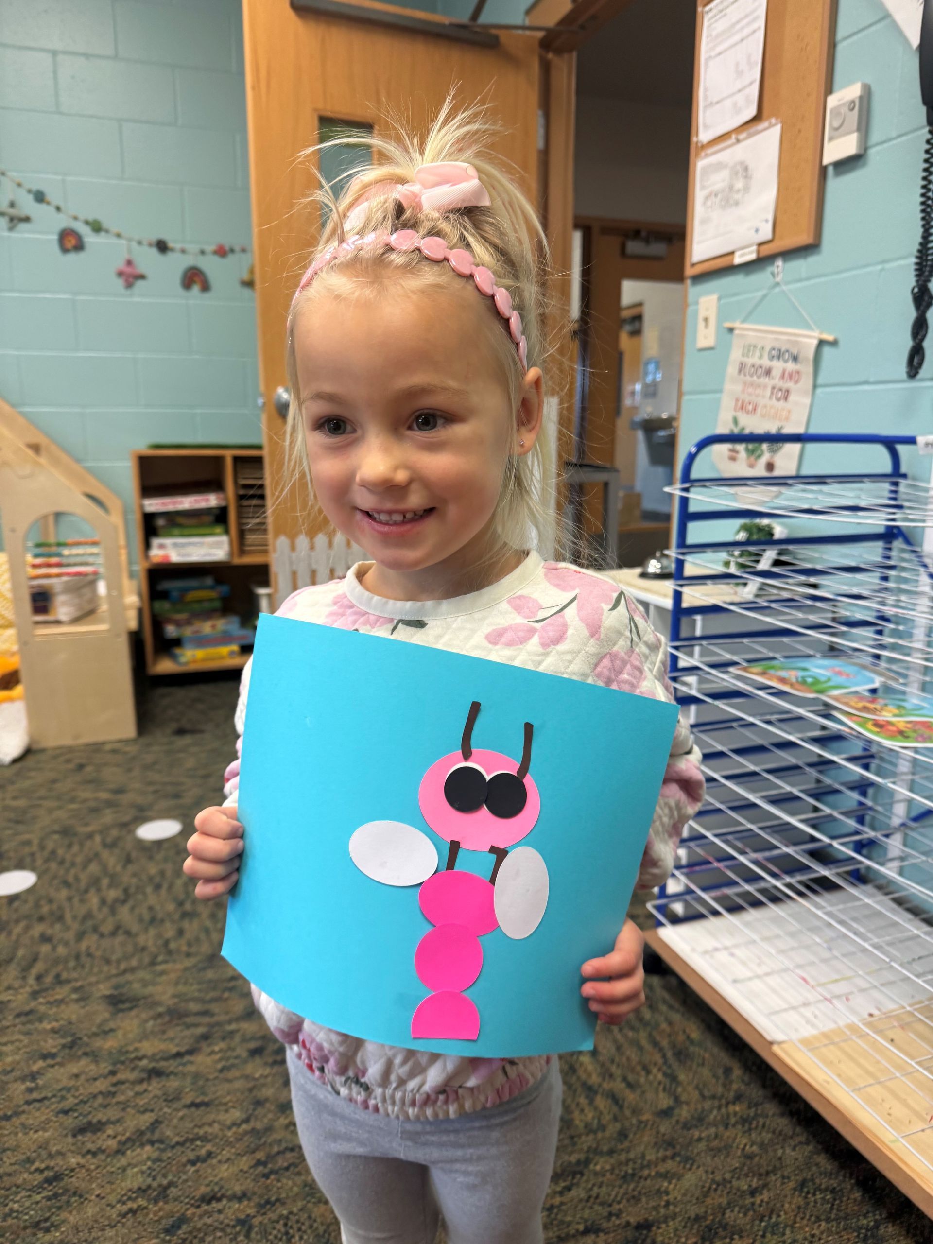 A group of children are sitting on the floor playing with toys.