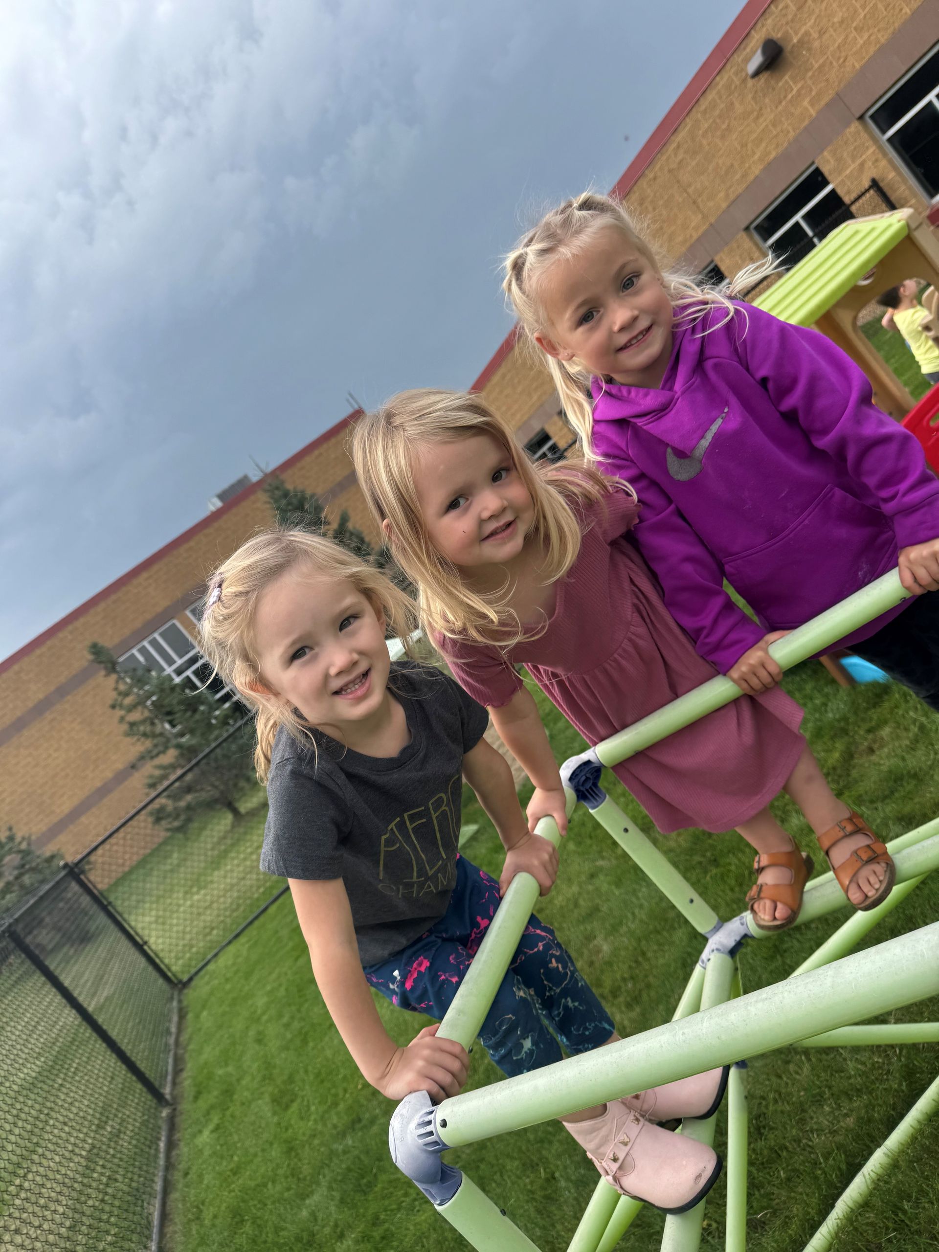 A group of children are sitting on the floor in a room.