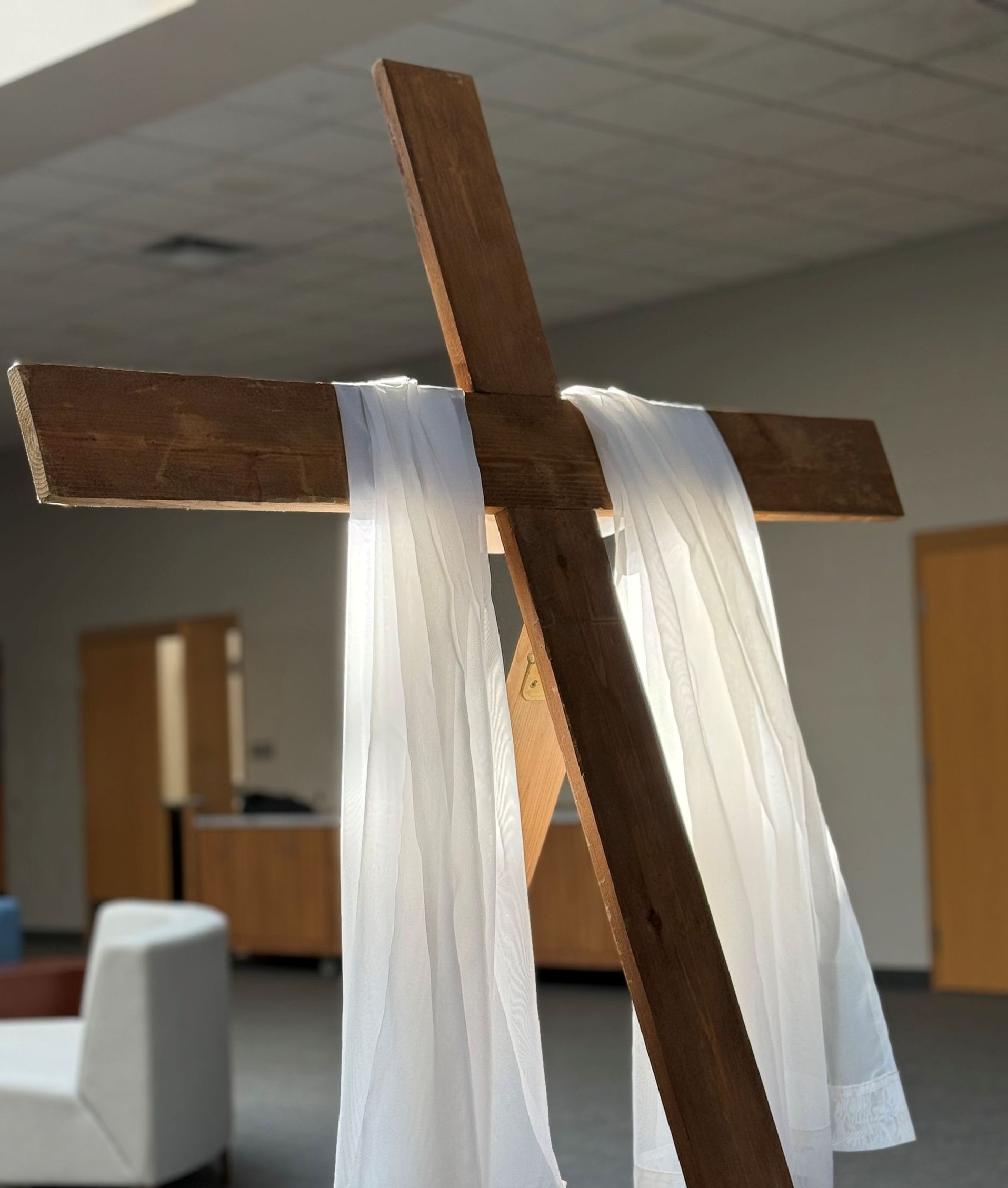 A wooden cross with a white cloth draped over it