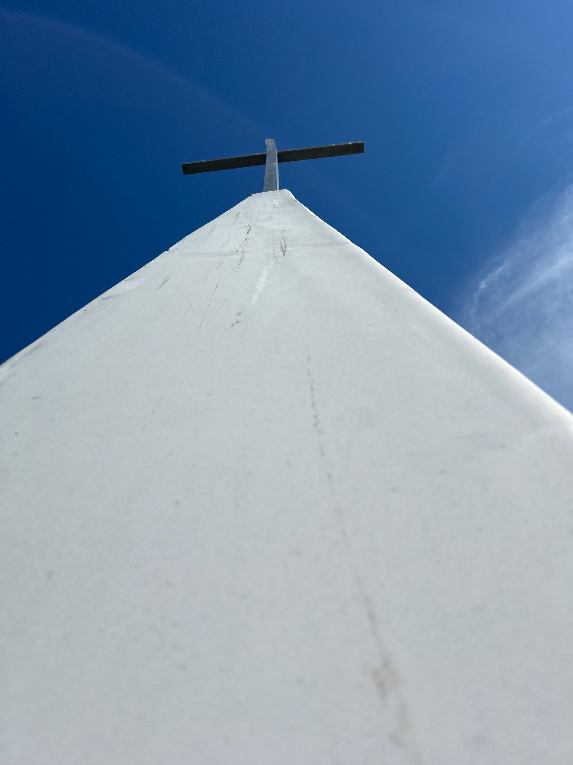 A white building with a cross on top of it