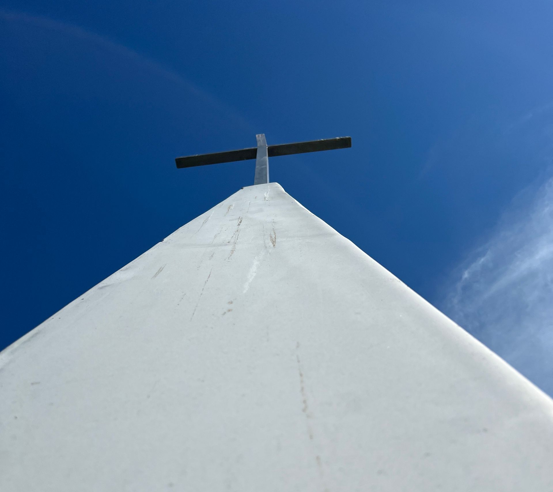 A white building with a cross on top of it