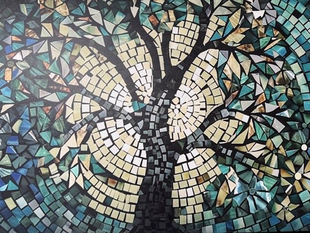 A mosaic of a tree with a flower in the middle