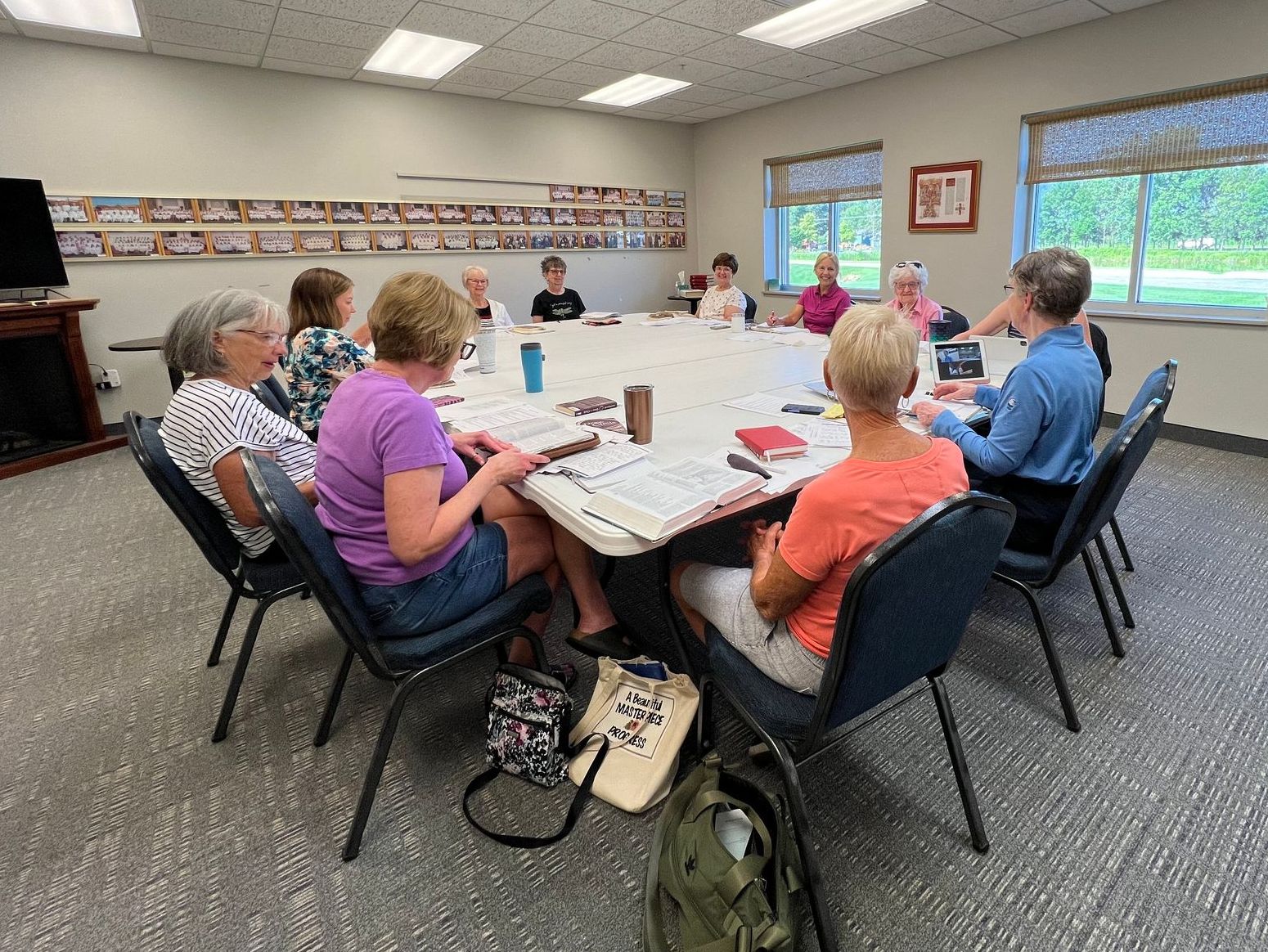 A group of people are sitting around a table in a room.