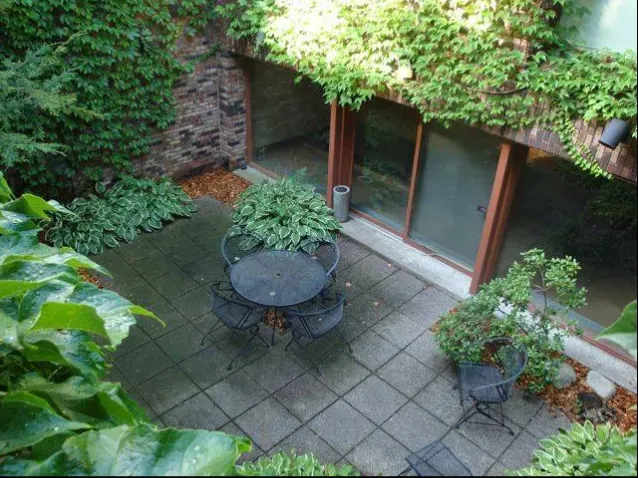 An aerial view of a patio with a table and chairs