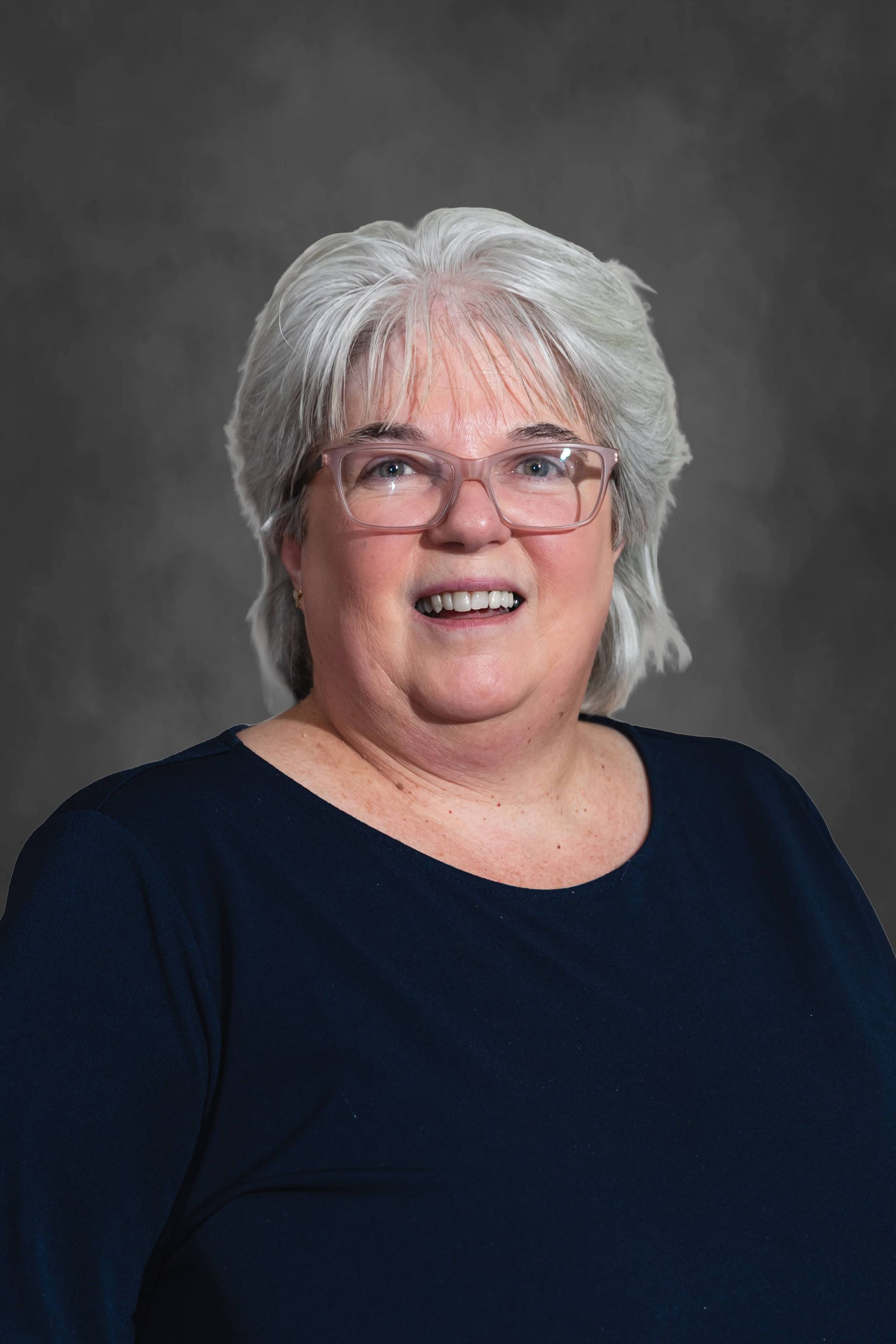a woman with long hair is smiling and wearing a black jacket .