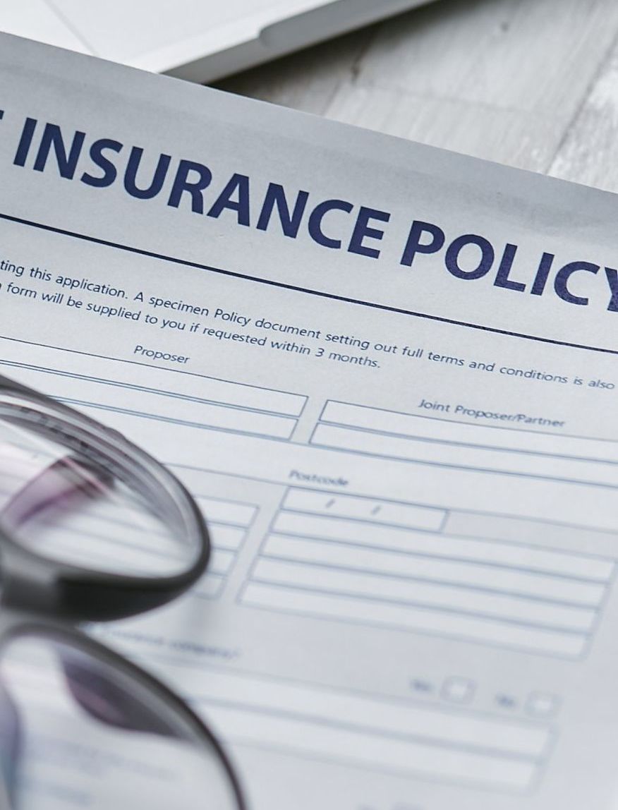 a close up of an insurance policy with glasses on it .