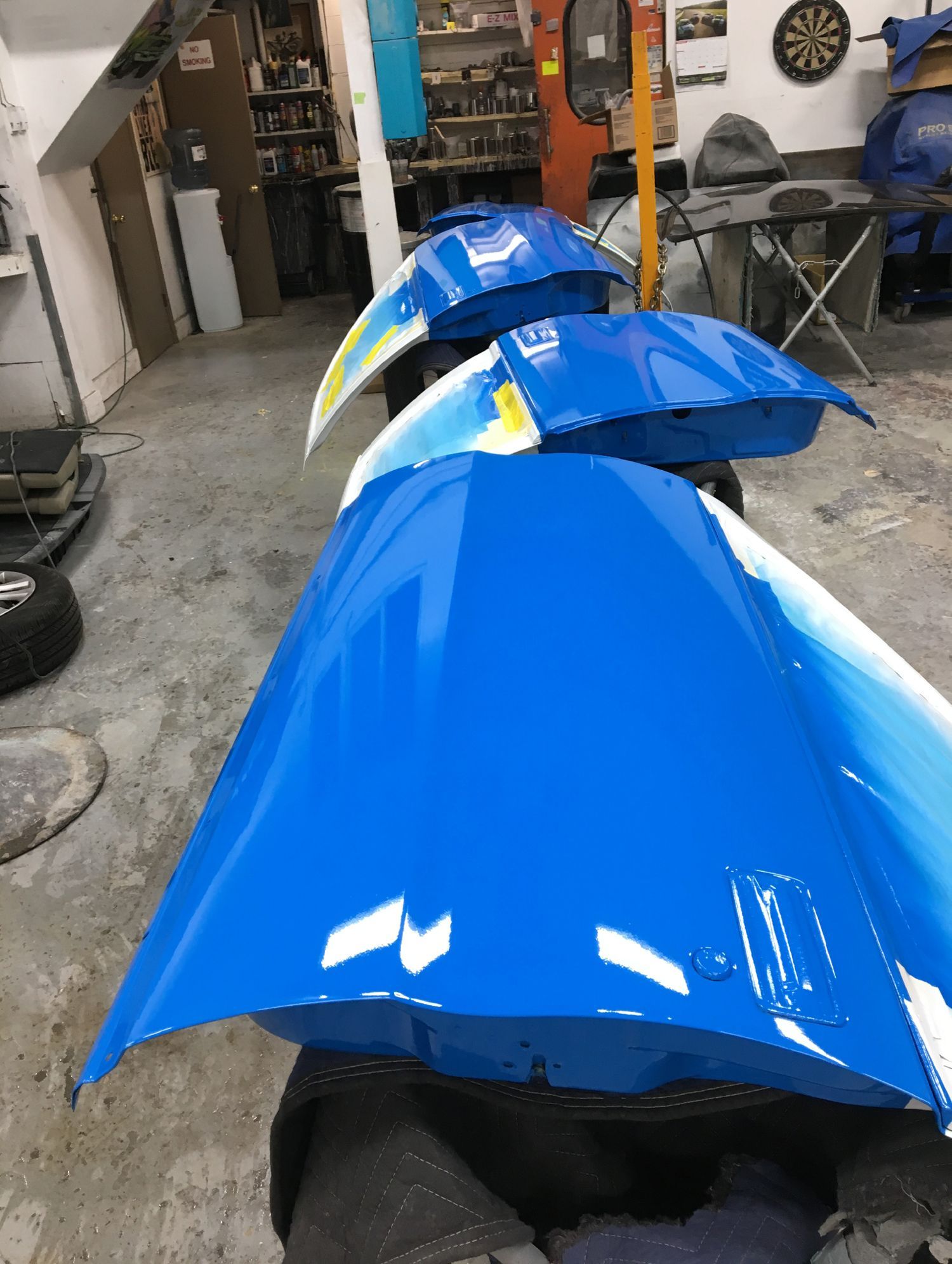 A row of blue and white umbrellas in a garage
