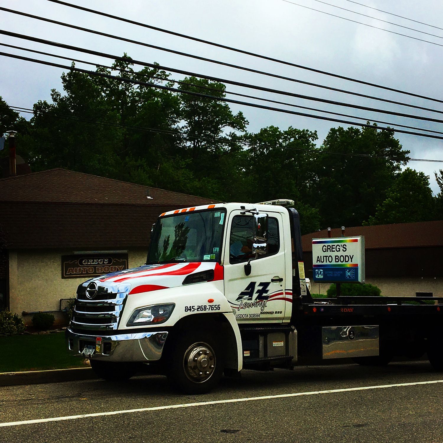 A tow truck is parked on the side of the road