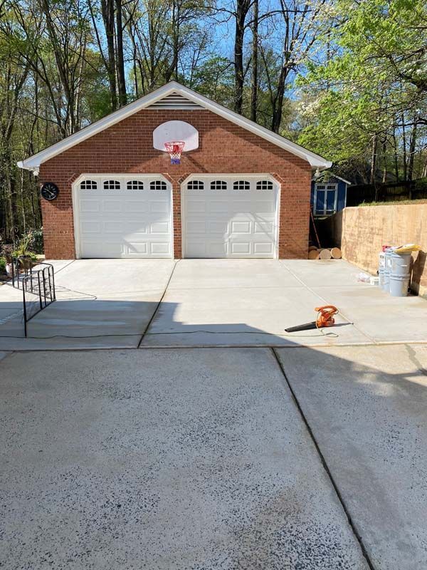 Brick two-car garage with basketball hoop above the doors