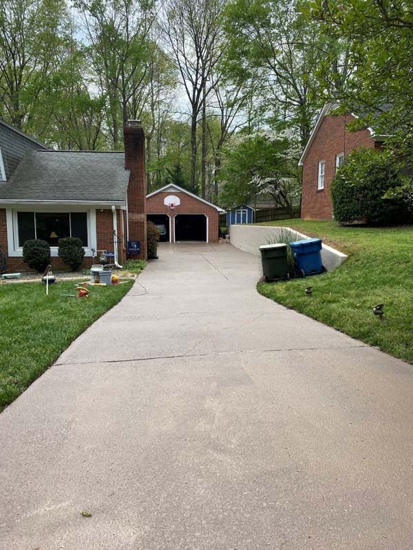 Driveway leading to a garage and house