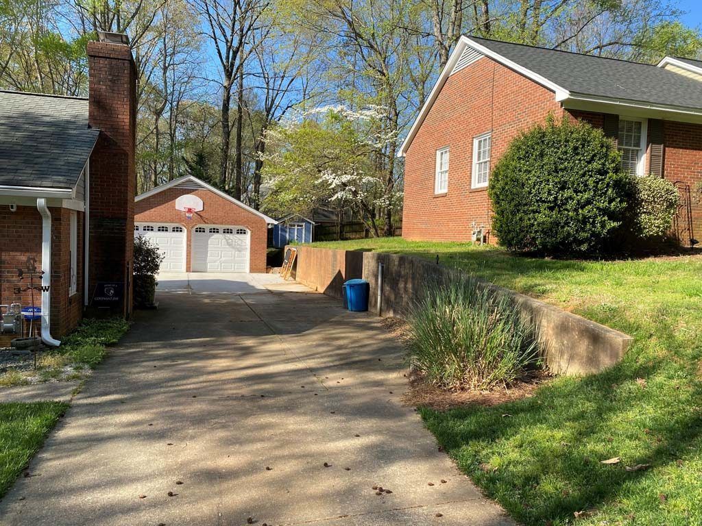 Driveway between brick houses with a detached garage