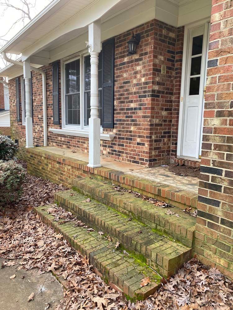 Brick steps leading to a house porch with white columns