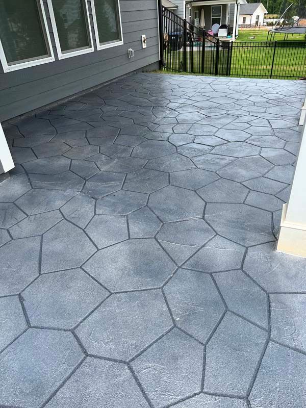 Stamped concrete patio with a stone pattern, brown and gray tones