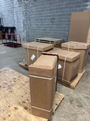 Cardboard boxes secured with white straps, stacked on pallets in a warehouse setting.