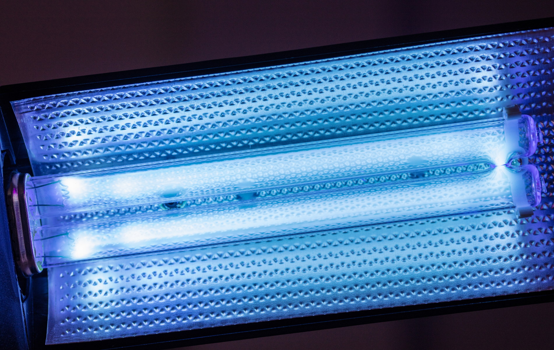 A close up of a uv light with a blue light coming out of it.