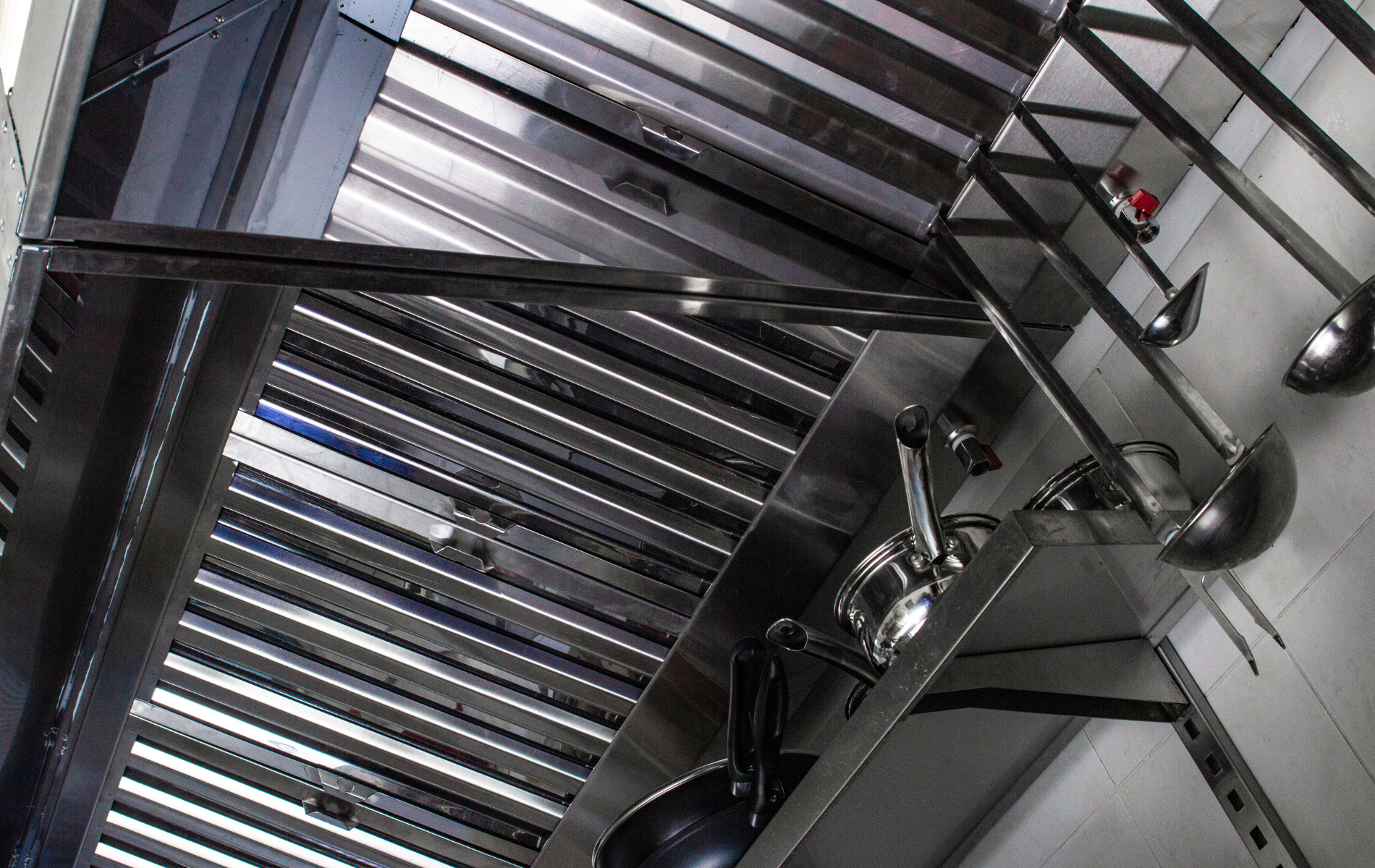 A kitchen with stainless steel appliances and utensils