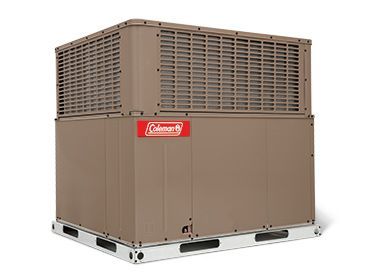 A coleman air conditioner is sitting on a pallet on a white background.
