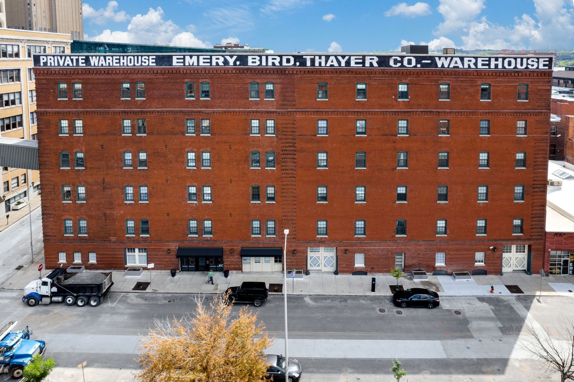 An aerial view of the red brick, six-story Emery, Bird, Thayer Co. Warehouse building on a sunny day.