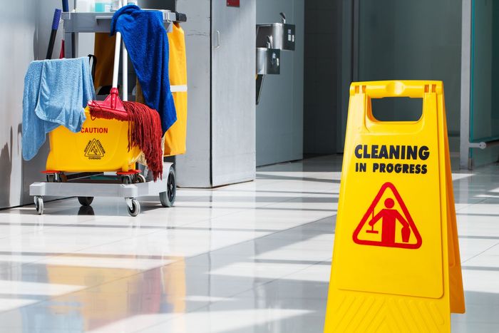 A yellow sign that says cleaning in progress on it