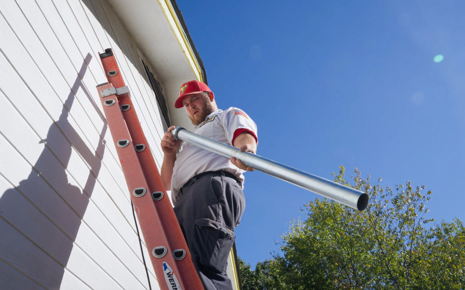 Man in Mister Sparky shirt installs tubing