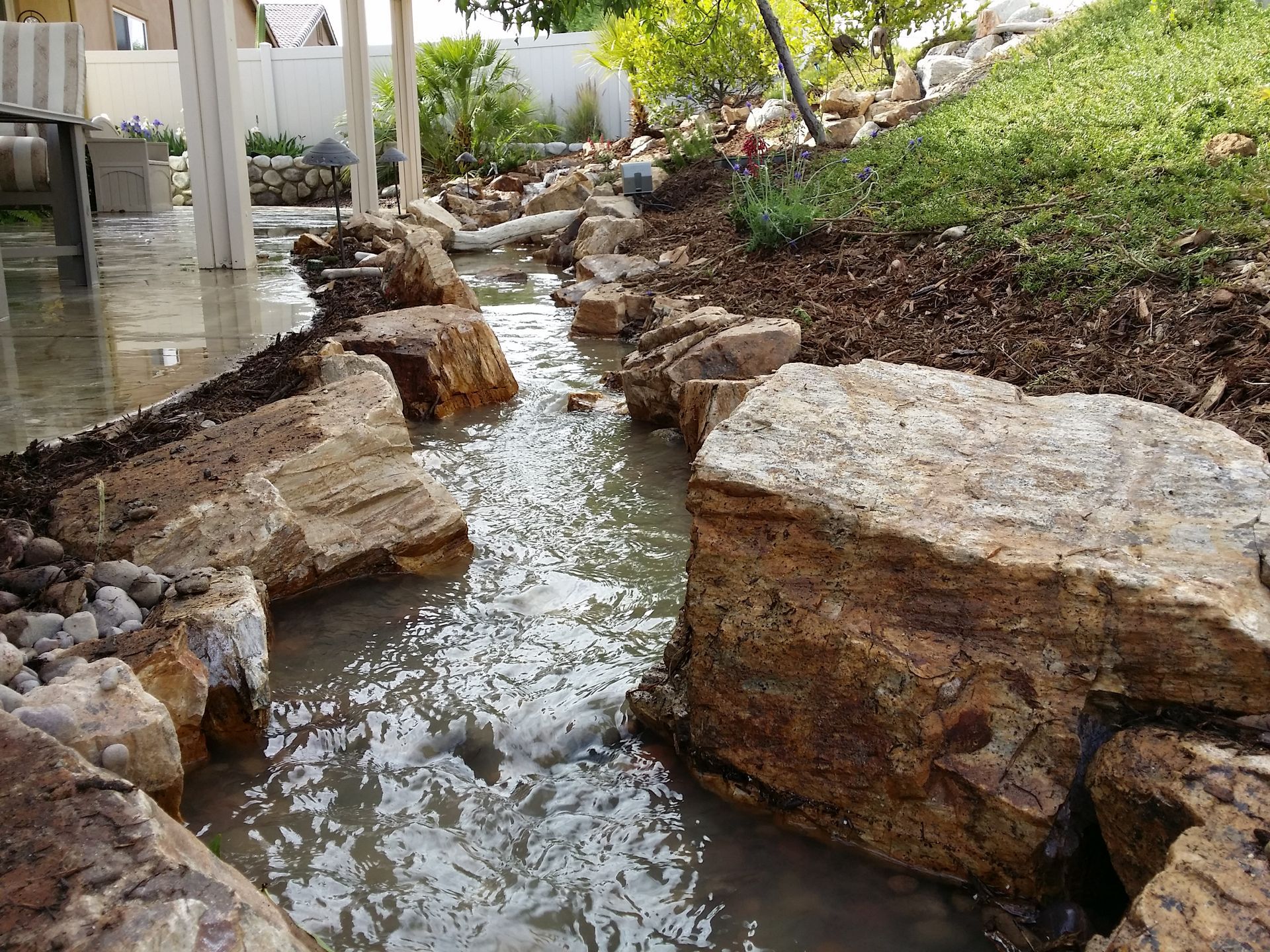 A stream of water is running through a rocky area.