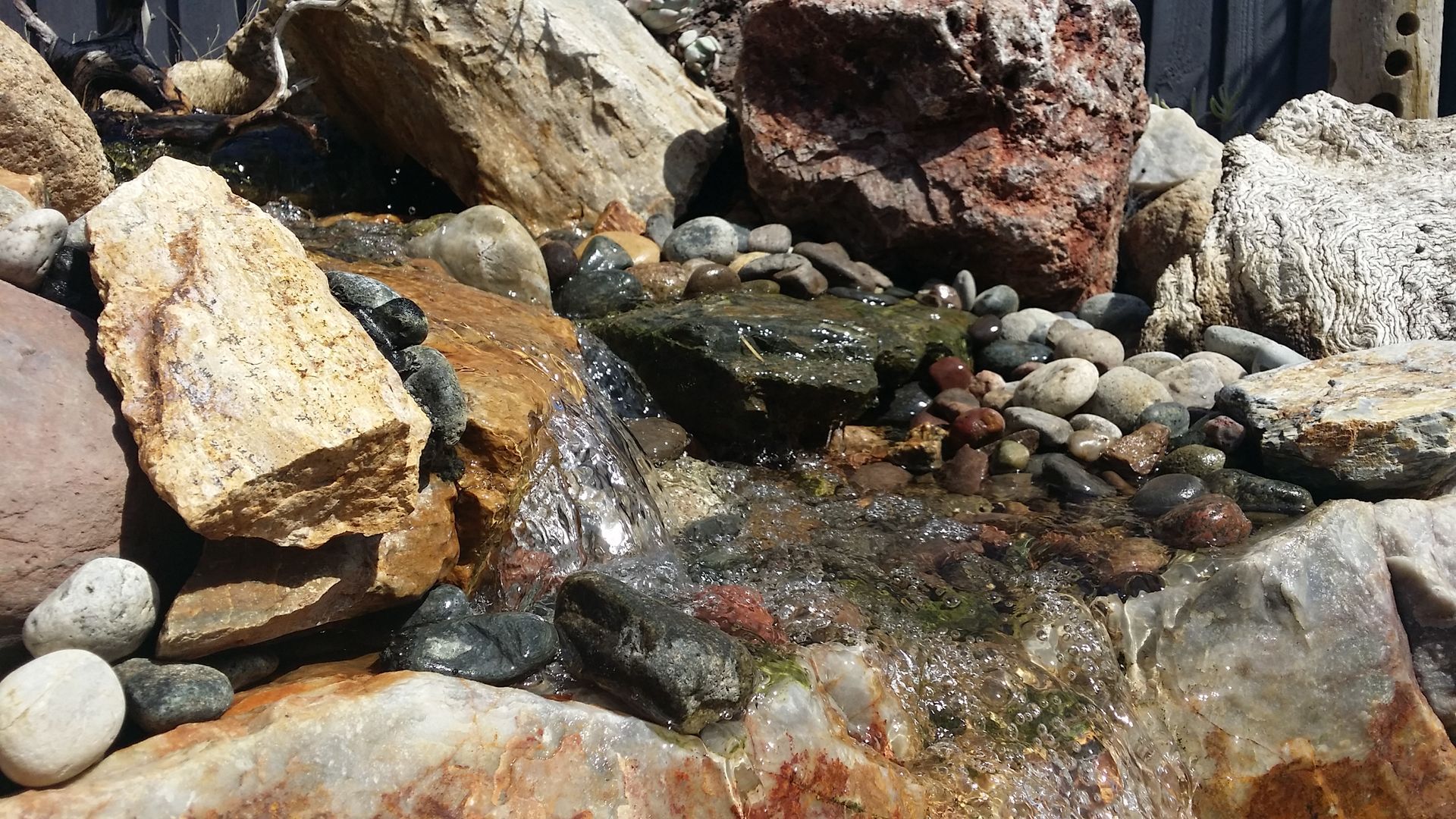 A pile of rocks with water coming out of them
