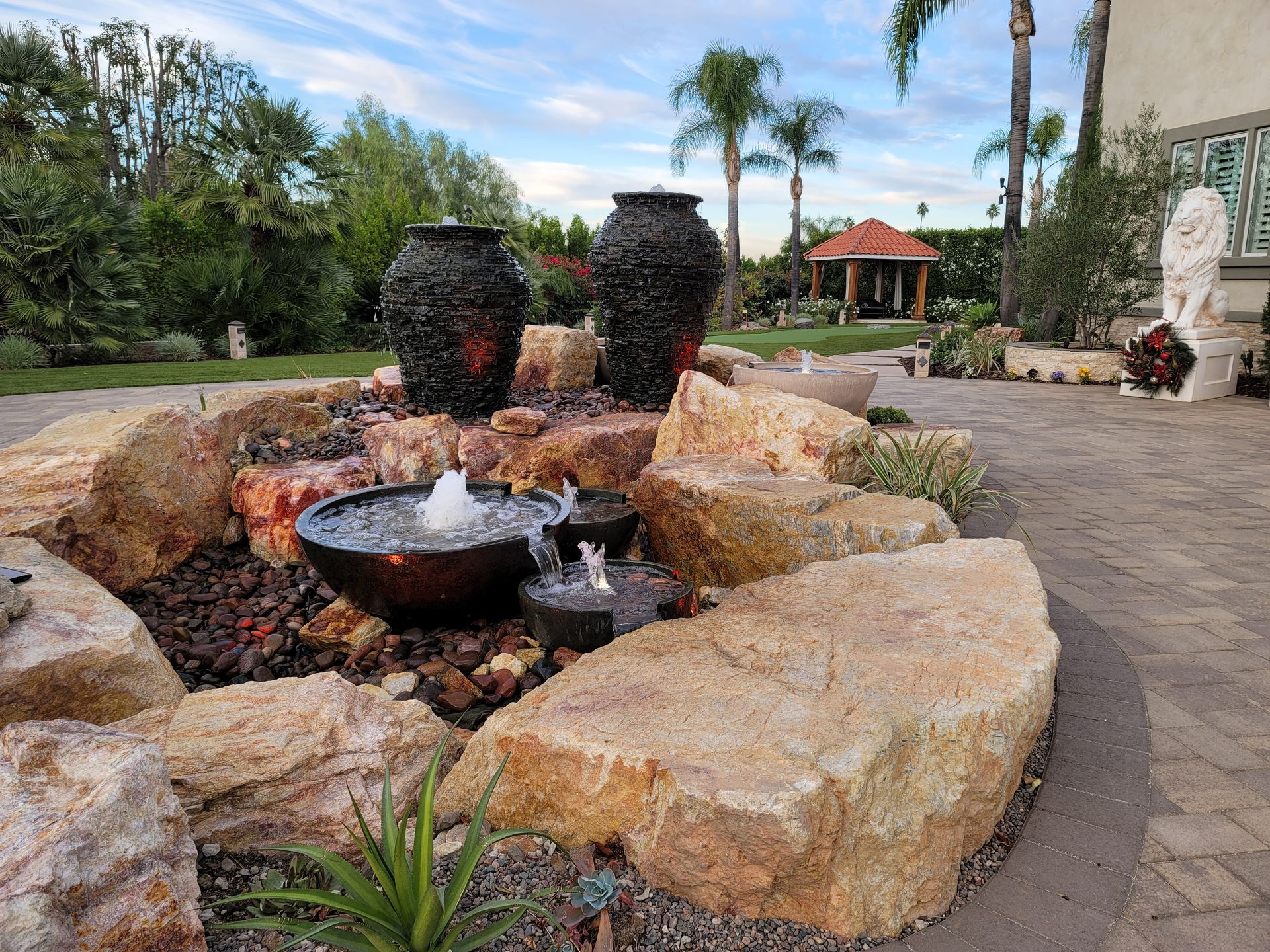 There is a fountain in the middle of the rocks.