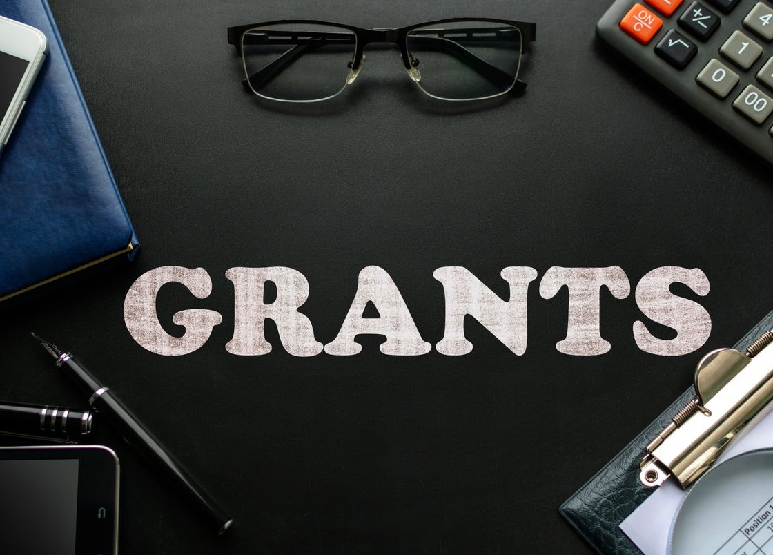 A desk with the word grants written on it