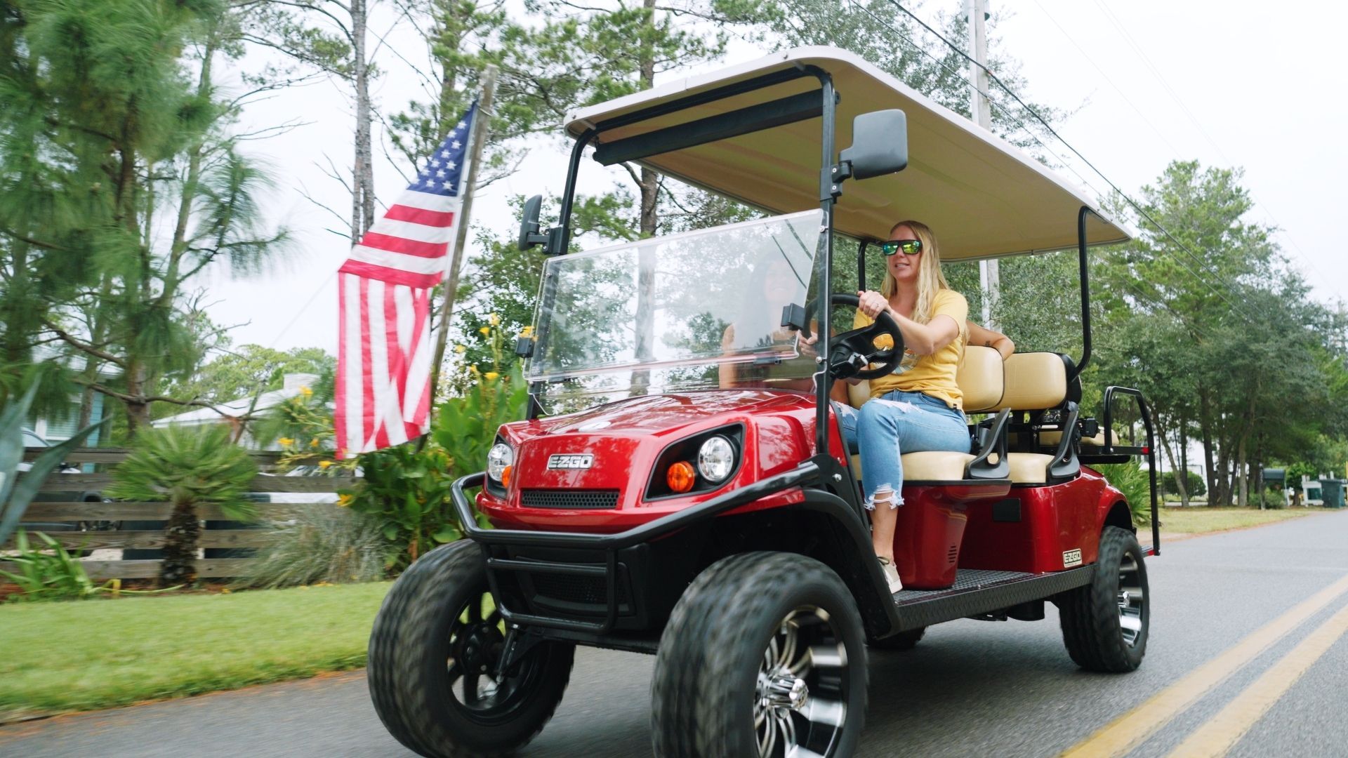 Girls in a golf cart rental driving on the road