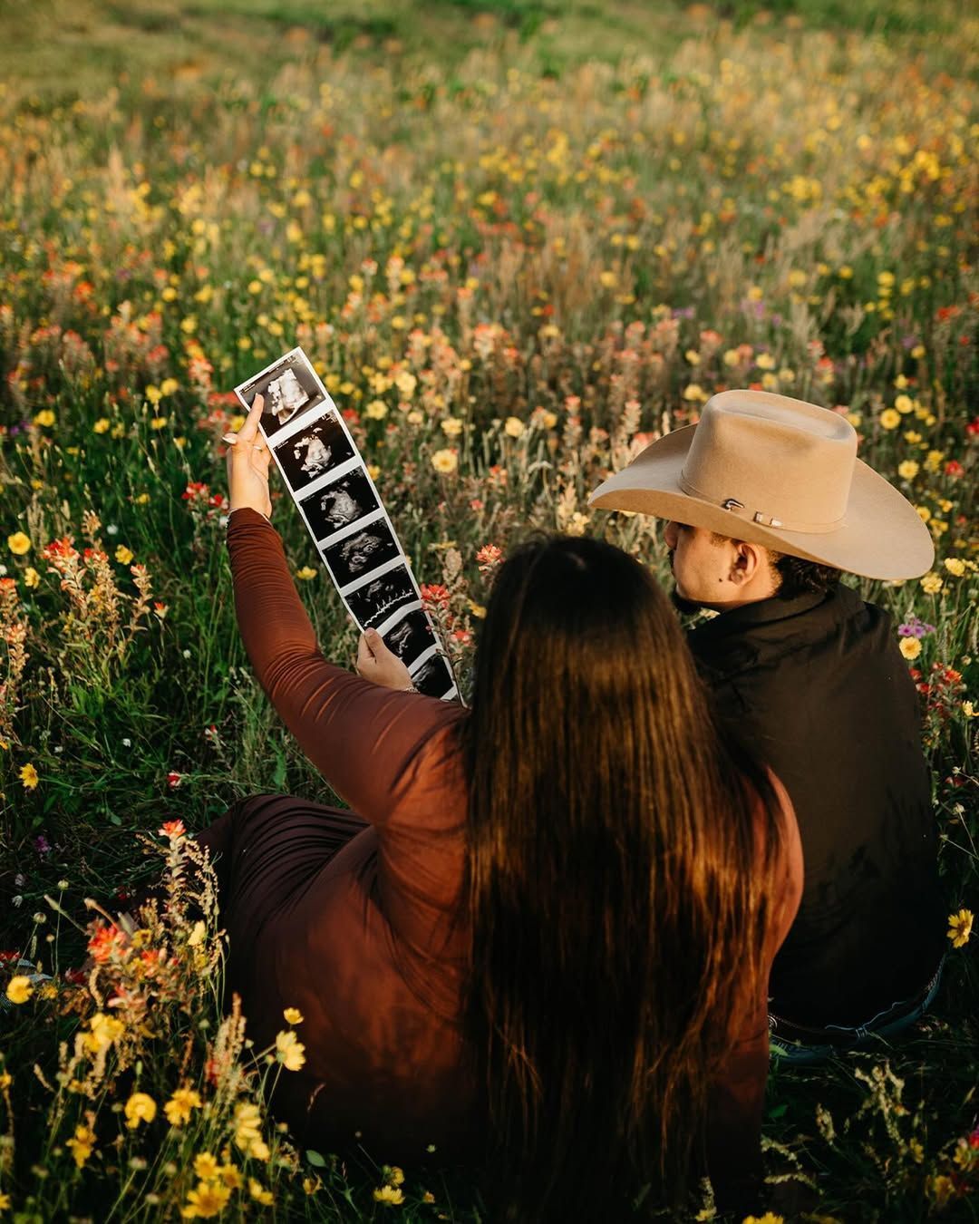 Expecting couple in an earthy outdoor setting