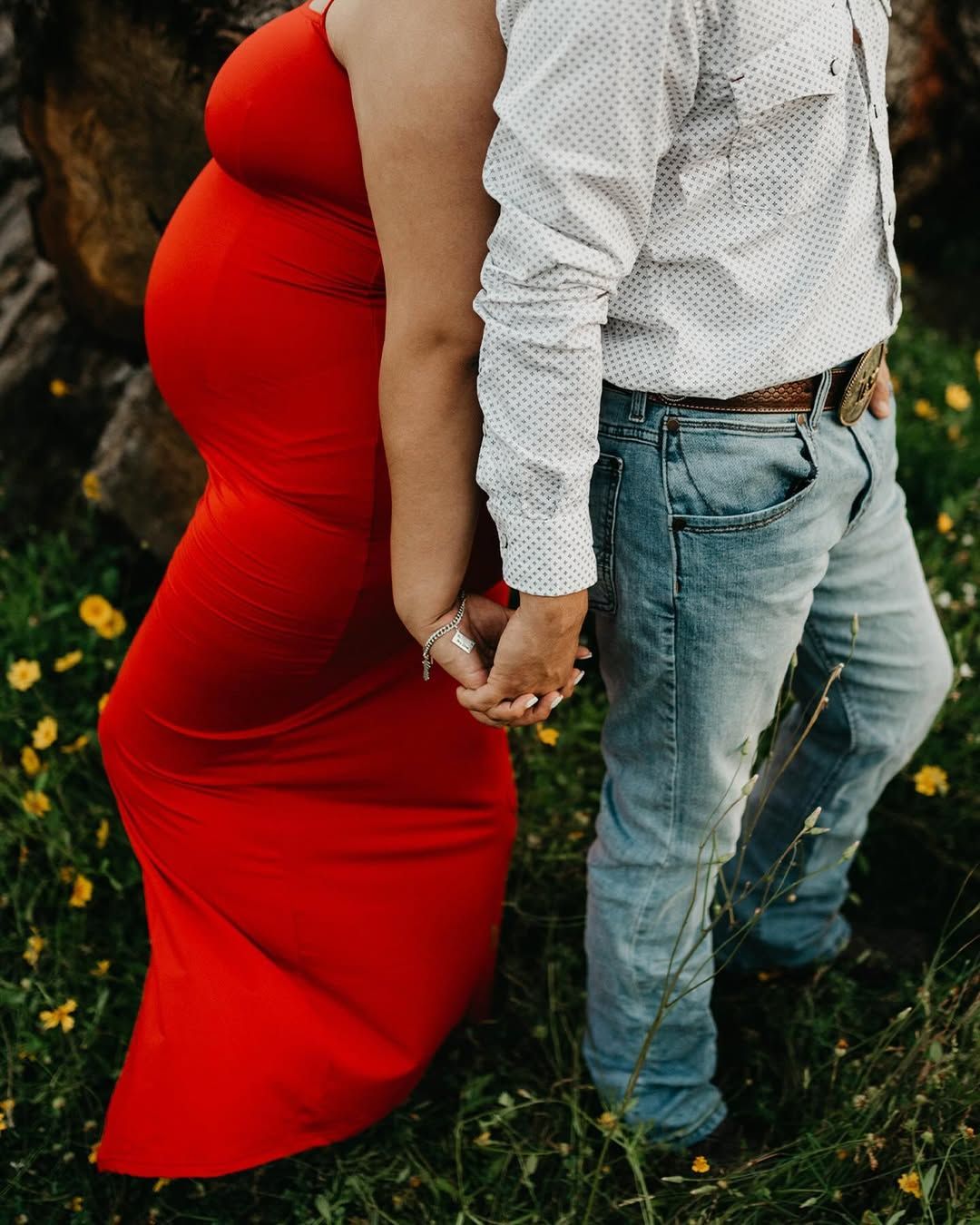 Close-up of Khia's maternity dress flowing in the breeze