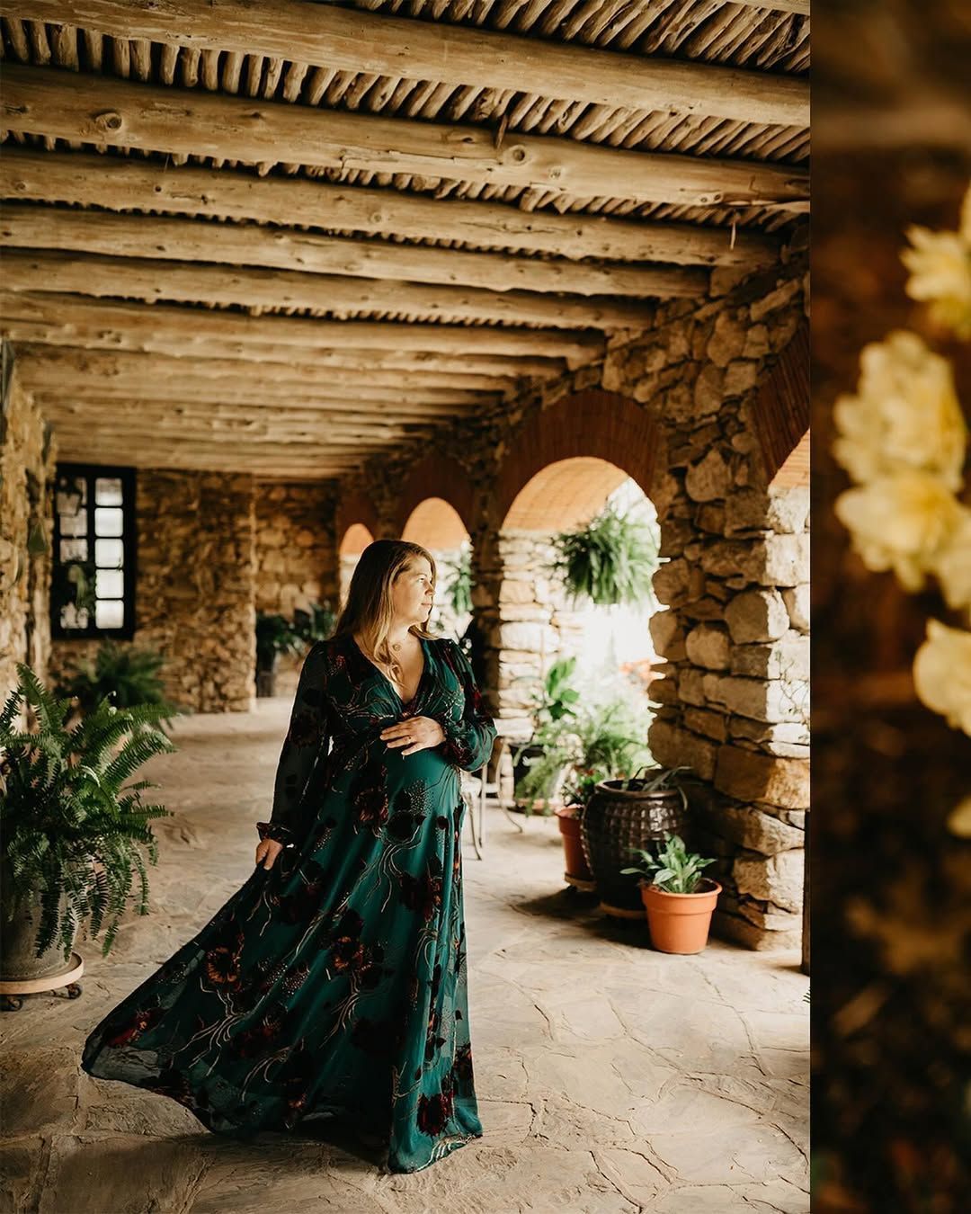 Megan embracing her baby bump during her maternity session at San Antonio Missions