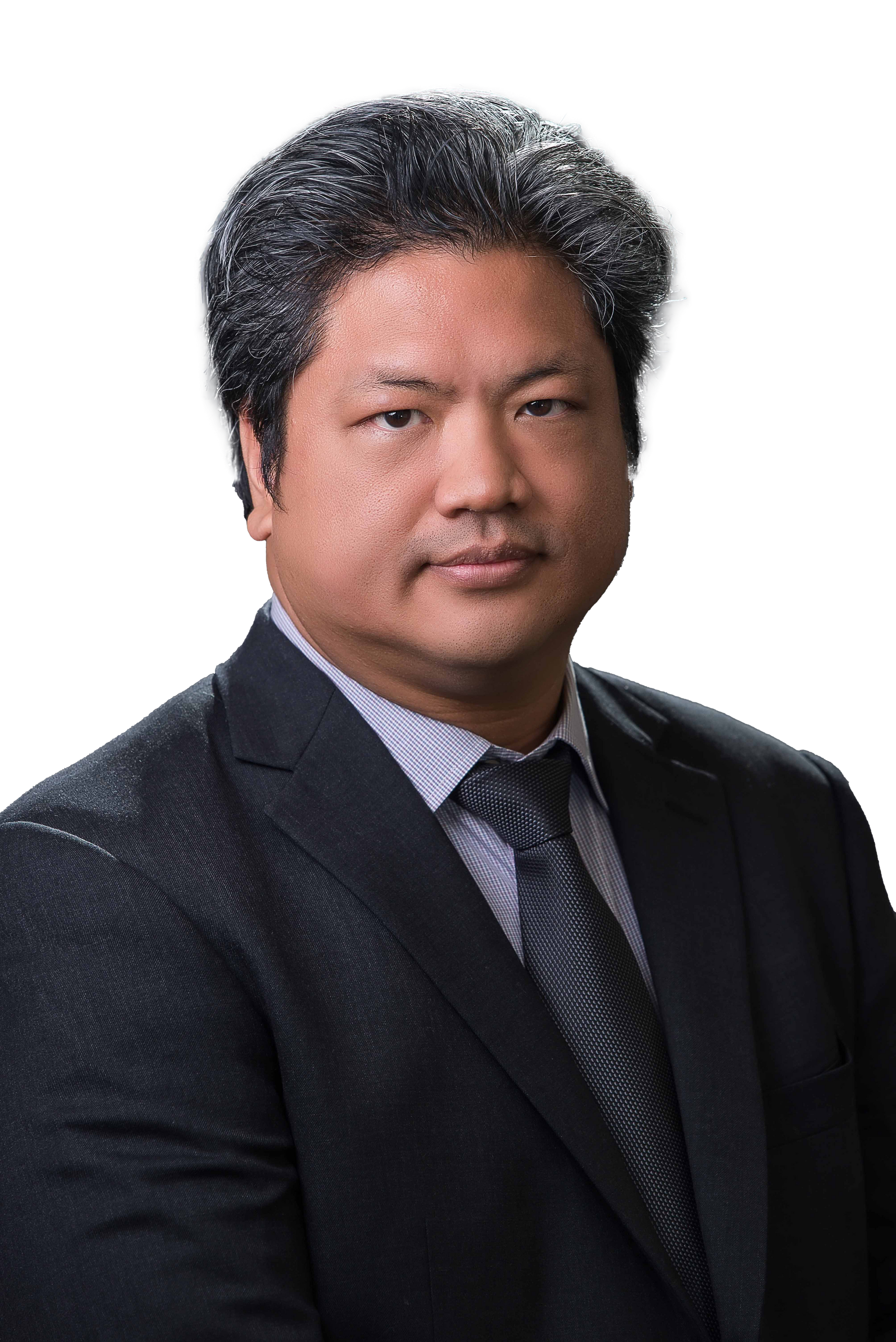 A man in a suit and tie is standing in front of a white background.
