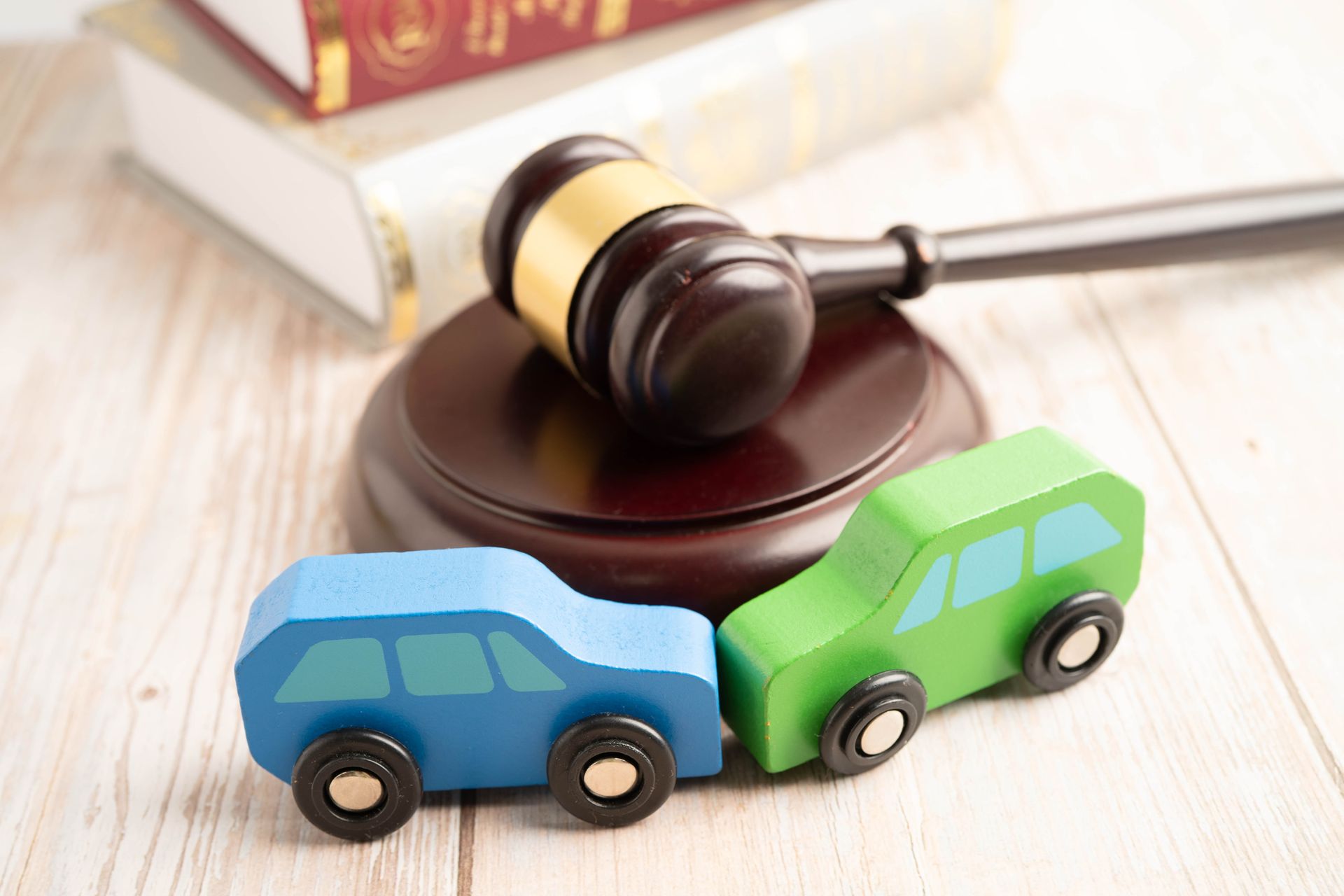 Judge hammer with car model, symbolizing a car accident lawsuit and insurance.