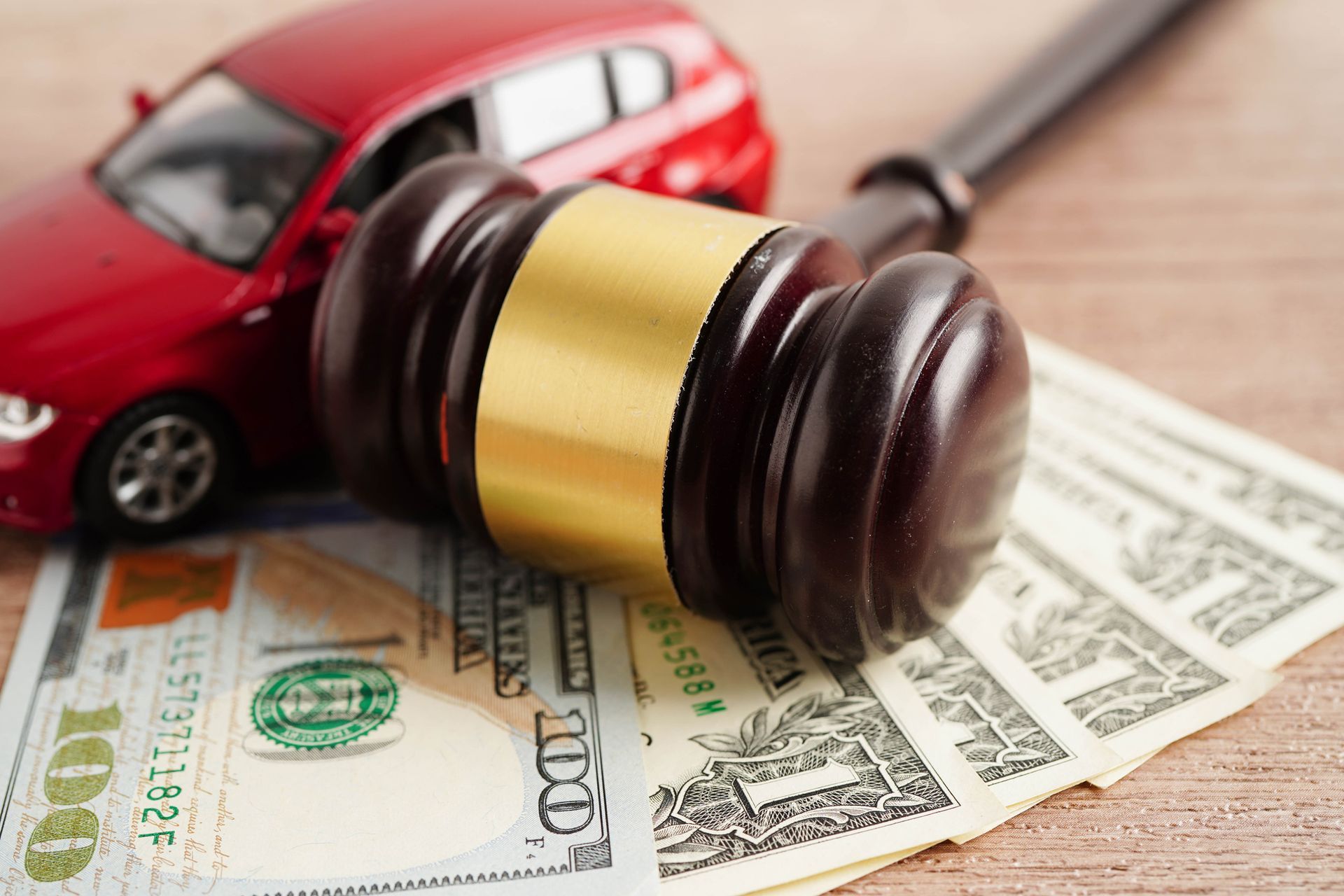 Judge hammer and money with car model. 