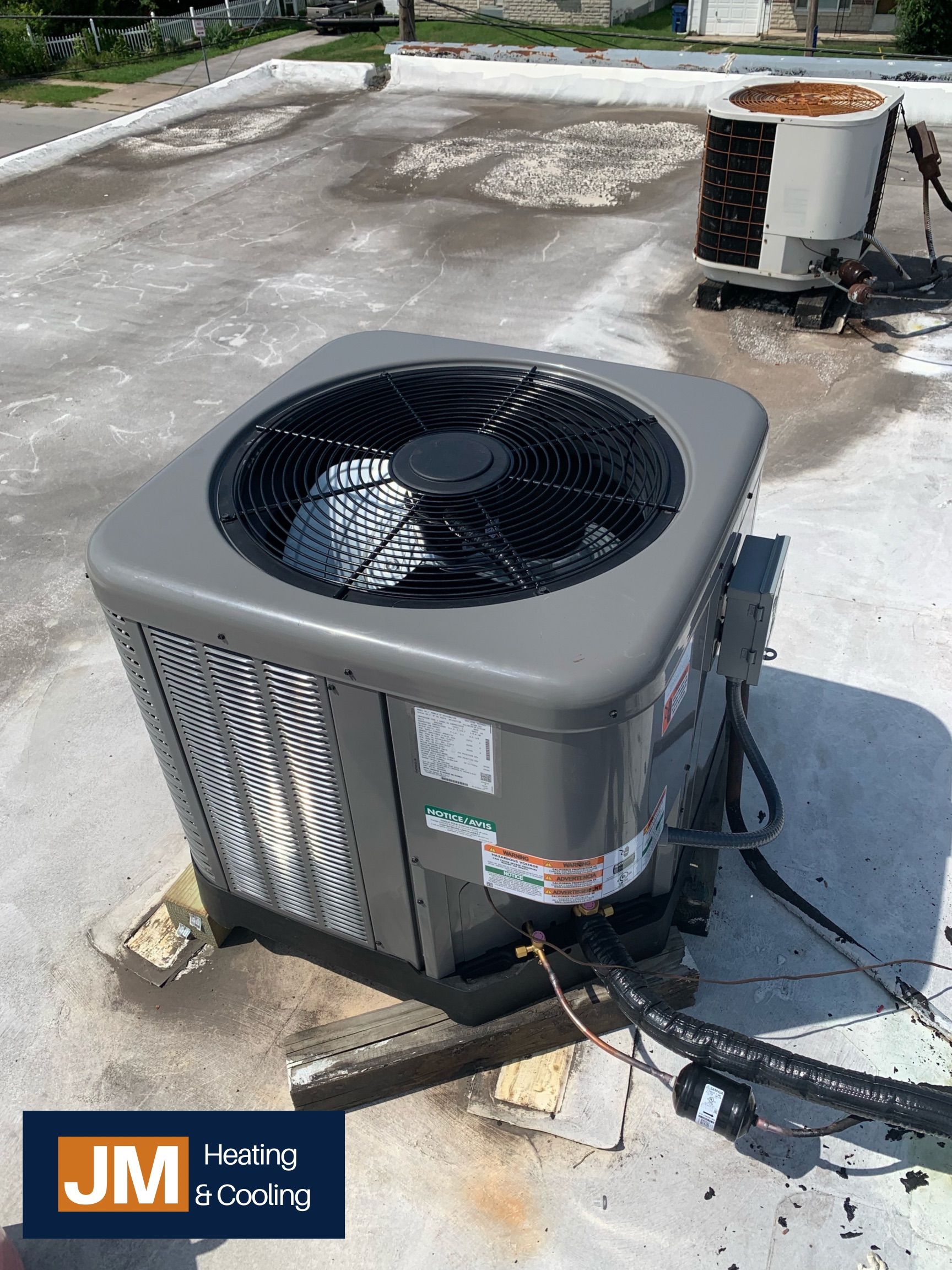 Air Conditioner Being Fixed — Springfield, MO — JM Heating & Cooling
