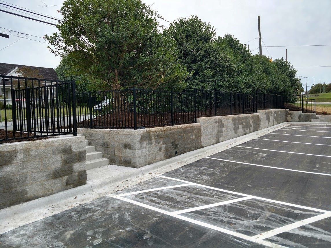 Aluminum fence and retaining wall by parking lot