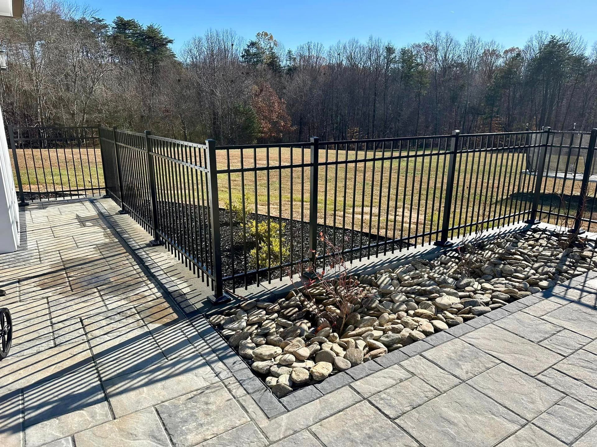 Aluminum fencing enclosing patio and landscaping