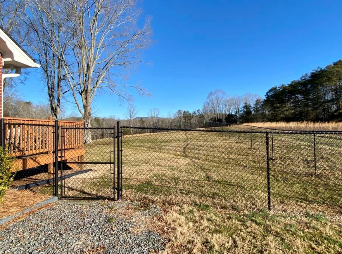Black vinyl-coated chain link fencing surrounding property