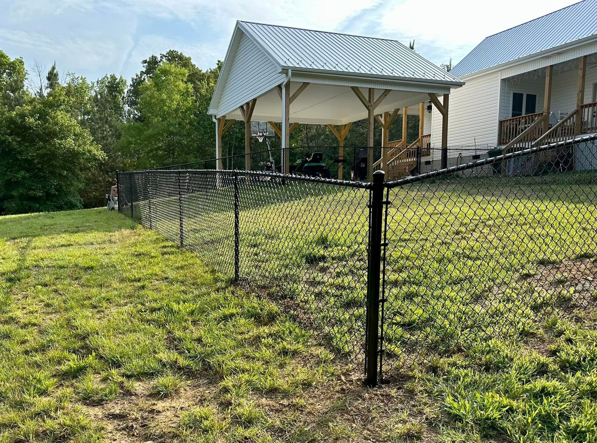 Black vinyl-coated chain link fencing surrounding backyard