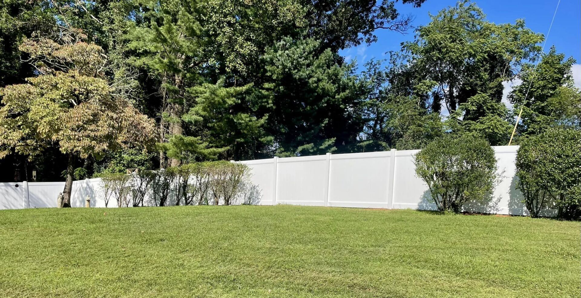 vinyl fencing along tree line