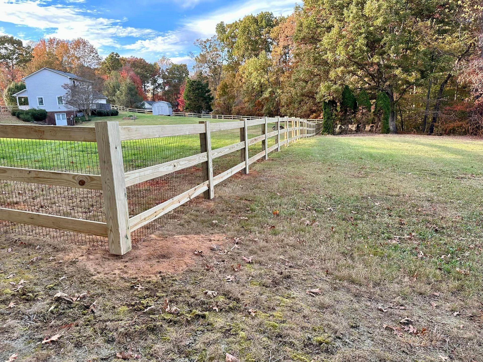 wood picket fencing with wire fencing