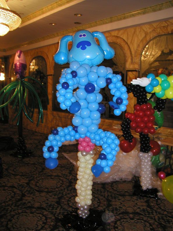 Blue balloon sculpture of Blue's Clues' Blue with other balloon figures in the background.