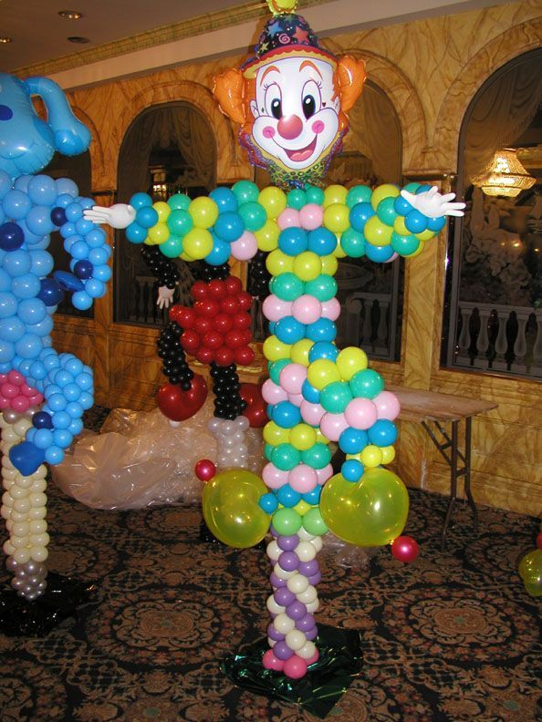 Balloon clown sculpture with colorful balloons, smiling face, and outstretched arms.