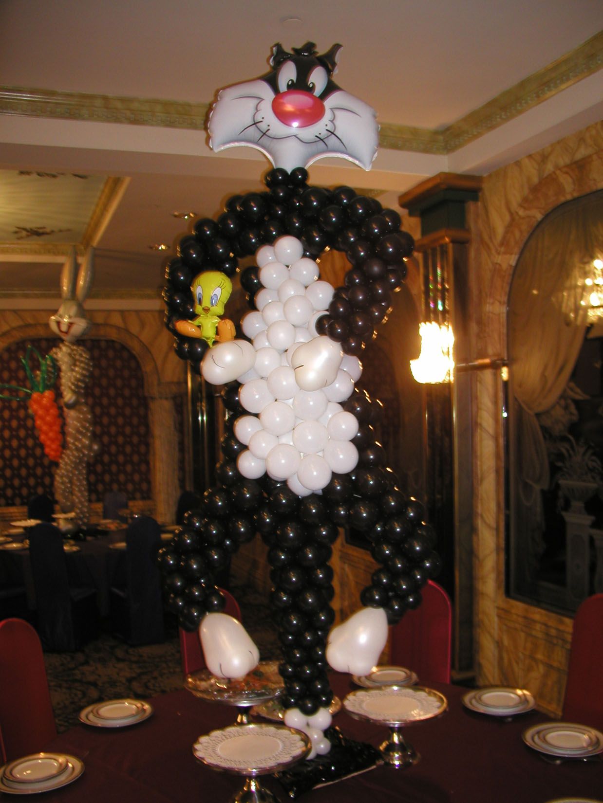Sylvester the Cat balloon sculpture with Tweety Bird at a table setting.