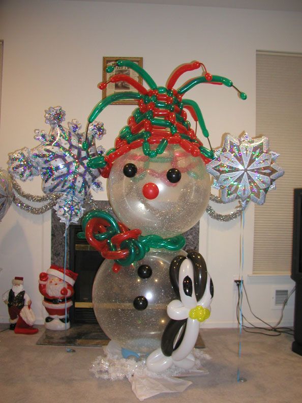 Balloon snowman with penguin, snowflakes, and festive decorations.