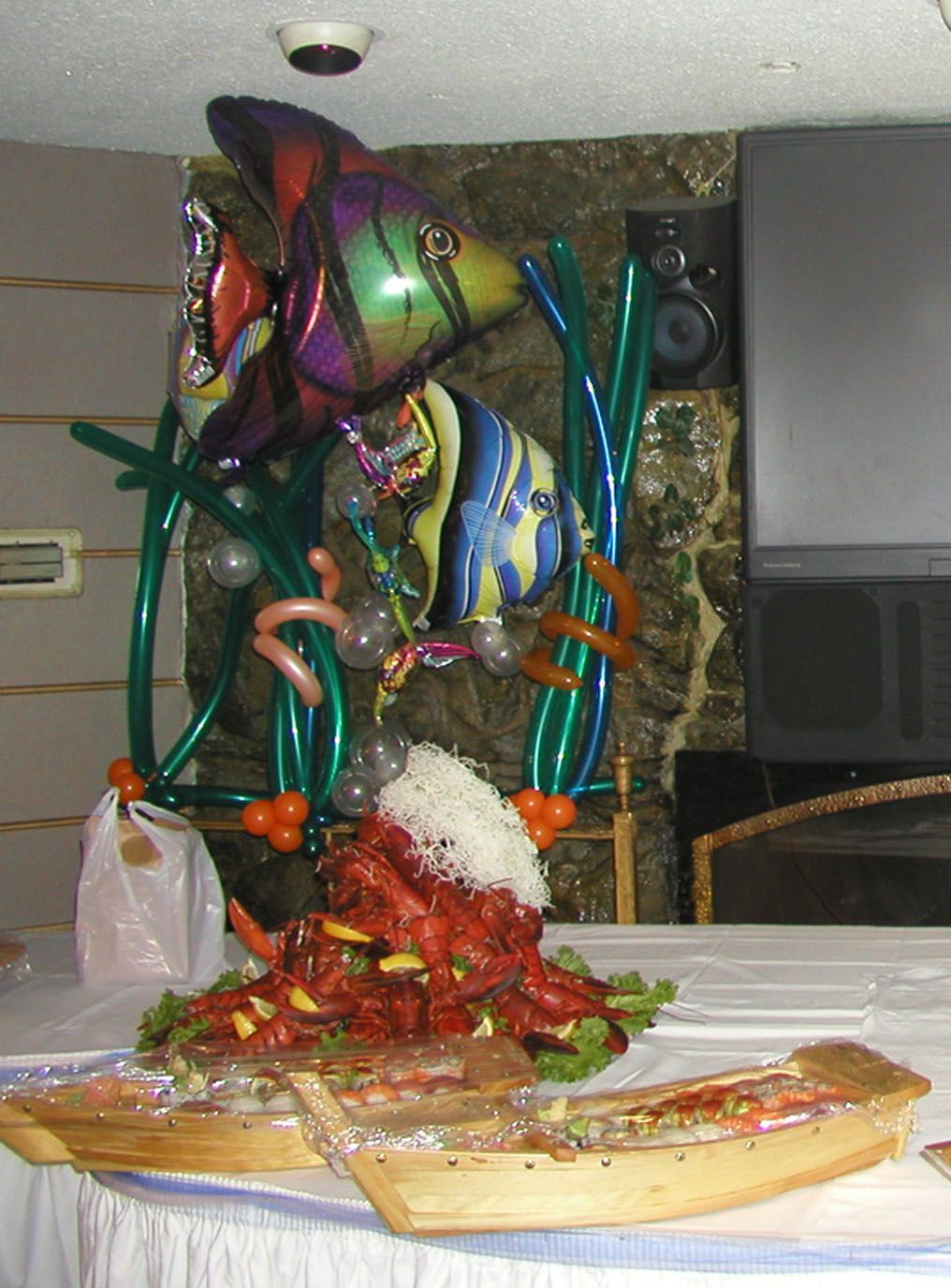 Balloon fish decoration above a seafood buffet table.